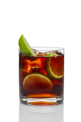 Cocktail with rum and cola with ice and lime in oldfashioned glass isolated on white
