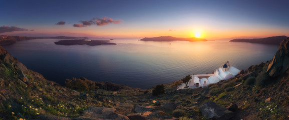 Fototapeta premium Amazing sunset at Panagia Theoskepasti, on the Skaros rock at Imerovigli, Santorini, Crete, Greece.