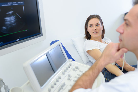 Woman having ultrasound, shocked expression