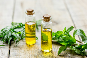 homemade spa with herbal extract in oil on wooden table background