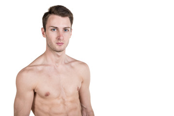 Healthy lifestyle and fitness. Handsome guy sports physique, with a naked body, on the left side of the frame, isolated on a white background. Horizontal frame