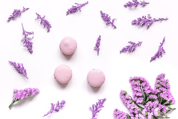 spring design in pastel color with macaroons and flowers top view pattern