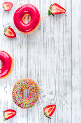 food design with strawberry donat on wooden table background top view mockup
