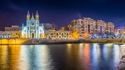 Fototapeta na wymiar Balluta bay, Malta - The famous Church of Our Lady of Mount Carmel at Balluta bay by night
