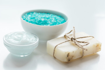 blue set for bath with salt and cream on white table background