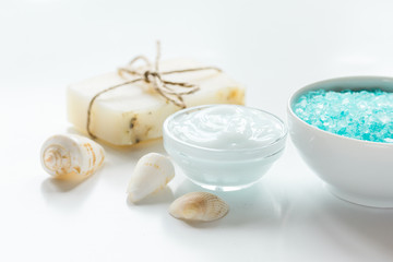 Fototapeta na wymiar Home cosmetic with cream and blue sea salt on white background