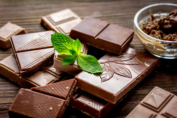 black and milk chocolate bars dark wooden table background