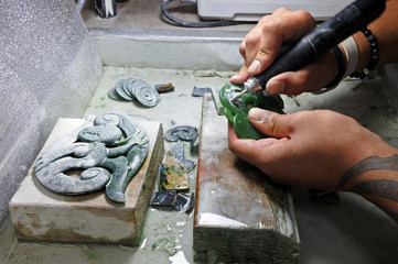 Hands of a Jade ornamental green rock carver at work - obrazy, fototapety, plakaty