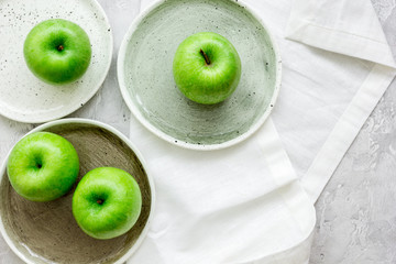 fresh organic green fruits with apples on stone background top view