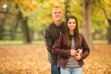 Fototapeta premium Young couple in love standing in a park
