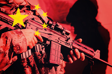 Soldier with machine gun with national flag of China