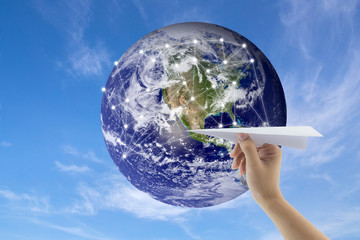 plane in hand with globe on background, Map world of flight routes airplanes network use for global...