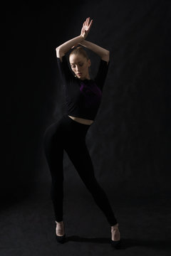 Vogue dancer posing on dark background