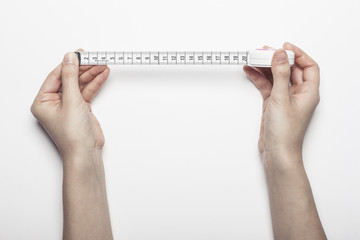 woman hand hold a measuring tape for diet isolated white, background.
