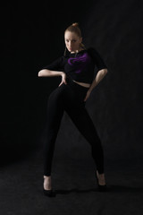 Vogue dancer posing on dark background