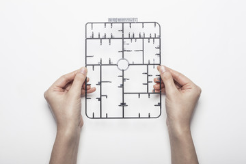 woman hand hold a plastic modeling parts isolated white, background.