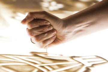 Sand animation.The girl's arm, drawing sand closeup