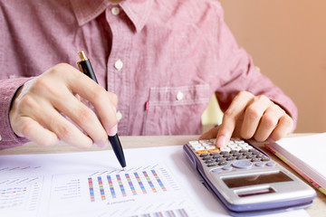 Close up people with calculator counting making document on table. Concept savings finances.