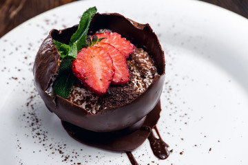 Plate with chocolate dessert and strawberry