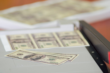 Us american dollar money bills printed in a sheet of paper in a paper cutter. Manufacture work