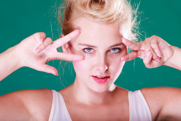 Woman with fingers close to eyes