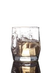 glass with ice and whisky isolated on white background