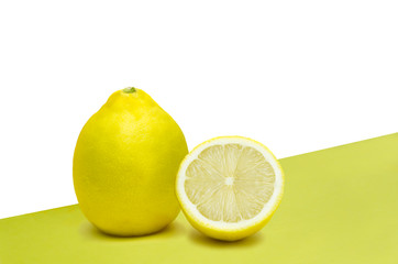 Fresh lemon on white and yellow background
