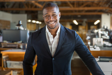 Portrait of professional business owner, man wearing suit at office workplace