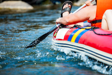 Obraz premium Focus some part of young person are rafting in river.