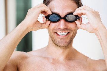 Portrait of  young smiling male swimmer in googles