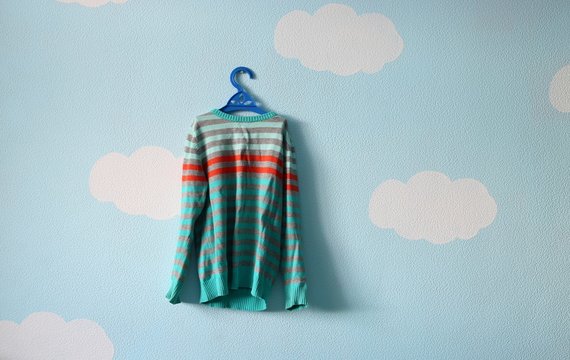 Baby Sweater On The Beautiful Blue Wallpaper