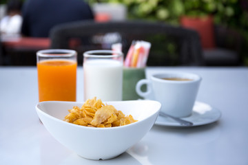 Breakfast set with cornflakes and cup of coffee