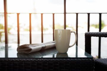 Cup of coffee newspaper on table