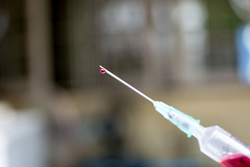 Conceptual syringe with blood