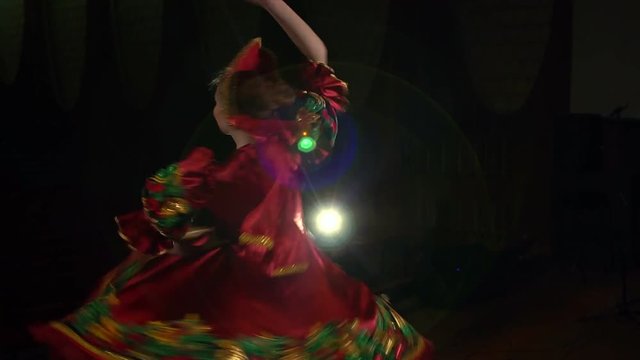 Folk dancer dancing on the stage in national costume, slow motion.