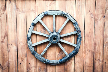 Background vintage wooden wheel on the boards