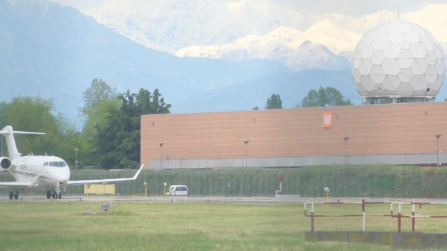 Jet Plane on Airport Takeoff Track and Mountains in the Background