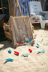 Paper Boat with shells and sand. Vocation and travel background