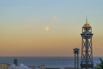 Barcelona lighthouse next to the moon