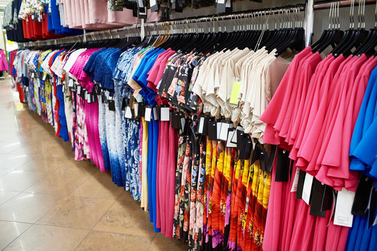 Different dresses on hangers in store