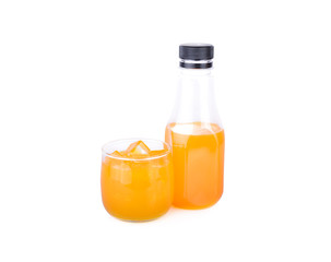 bottle and glass of orange juice on white background