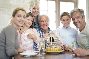 Obraz na płótnie Canvas Family celebrating grandfather birthday together