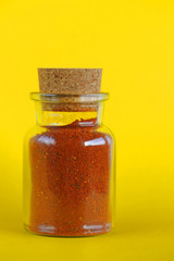 mixture of red chili peppers and paprika in a glass bottle 