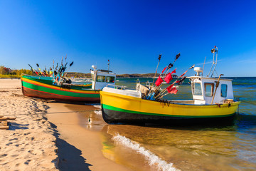 VIbrant fishing boats on the sandy beach of Baltic sea in Sopot, Poland