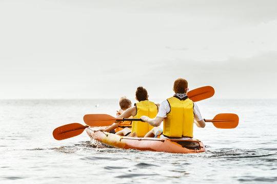 Family with son kayaking sea concept