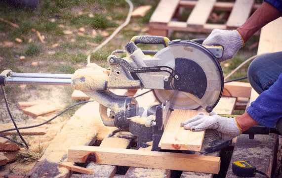 Cutting a tree with a circular saw in the workplace.