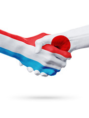 Flags Luxembourg, Japan countries, partnership friendship handshake concept.