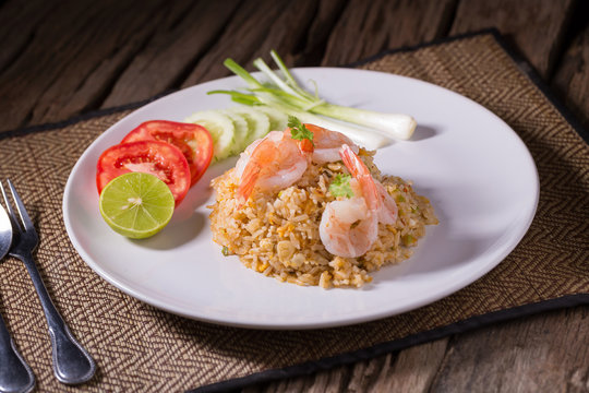 Thai fried rice with prawns in a white plate.