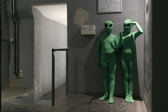 two young kids dressed as green aliens