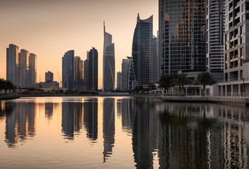 Fototapeta na wymiar Refelctions of Jumeirah lakes towers at dusk, Dubai, United Arab Emirates